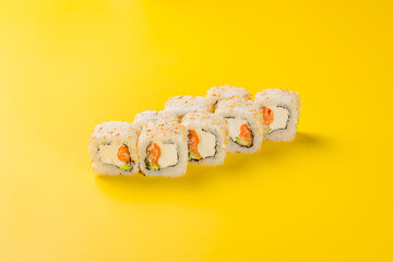 Alaska roll with salmon on yellow background