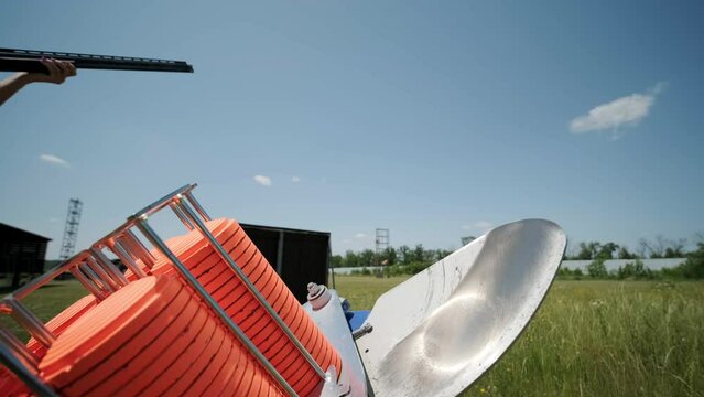 Slow Motion Clay Pigeon from the Side. Bench shooting on plates. V-log Bench shooting on plates. Automatic machine for throwing plates for shooting. Throwing machine for bench shooting.