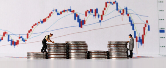 The concept of stock investment. Business concept with pile of coins and miniature people and...