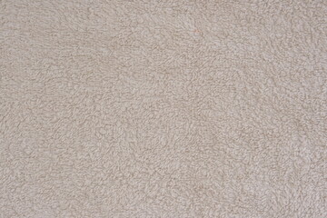 Fluffy gentle pastel biege fabric with waves and folds. Soft pastel textile texture.