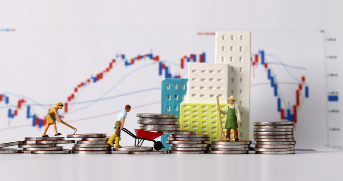 The concept of real estate investment. Business concept with miniature people and coins and graph.
