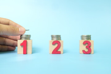 Investing asset allocation and diversification concept. Human hand stacking coins on multiple blocks.	