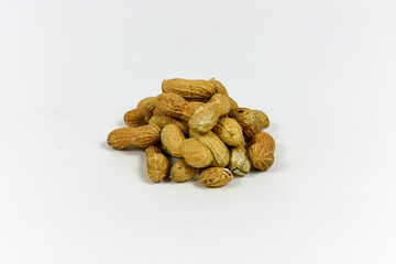 Fototapeta na wymiar A grouping of peanuts on a white background.