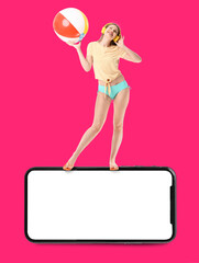 Young woman with inflatable ball and headphones and big mobile phone with blank screen on color background