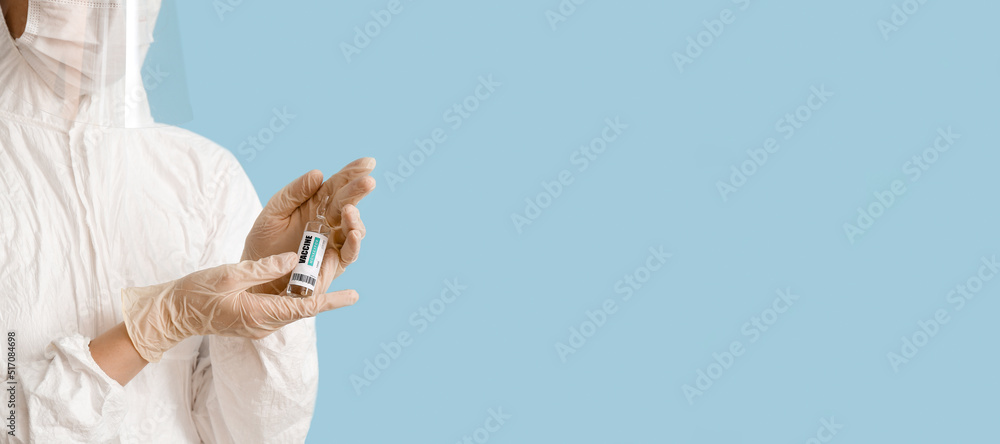 Wall mural Scientist holding monkeypox vaccine on blue background with space for text