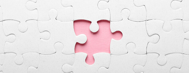 White jigsaw puzzle with missing piece, closeup