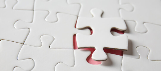 Jigsaw puzzle on table, closeup