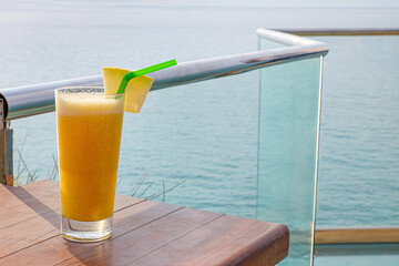 Glass of fresh tropical cocktail on table at sea resort