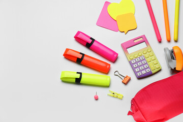 Pencil case and different stationery on white background