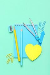 Composition with stationery and sticky notes on color background