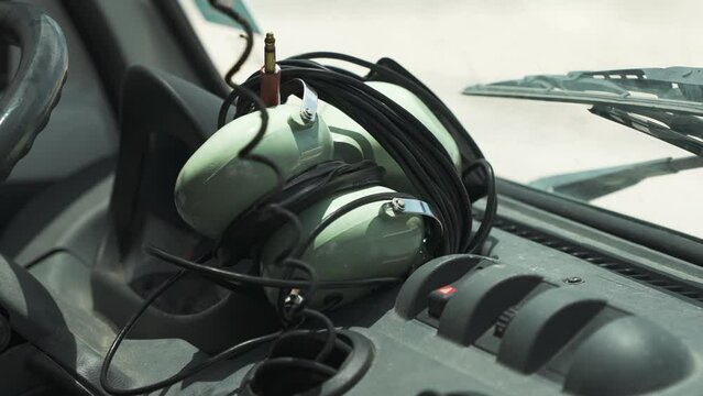 Close-up of big headphones on the dashboard of an airport service car