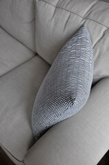 Beautiful pattern pillow setting on light gray comfy sofa