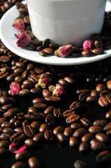 Coffee beans and preserved rose buds for tea drink in sunset