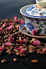 Coffee beans and preserved rose buds for tea drink in sunset