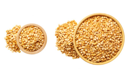 Grains dried peas are scattered out of the wooden bowl top view.