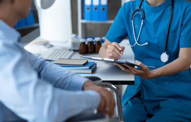 Doctor and patient sitting and talking at medical examination at hospital office, close-up....