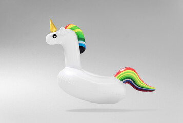 Creative art minimal aesthetic. Inflatable unicorn pool toy on light background. Minimal summer concept © Vidic Bojan