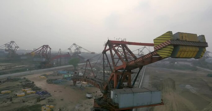 Stacker Reclaimer Equipment At The Coal Yard Of Paradip Port In Odisha, India. drone shot