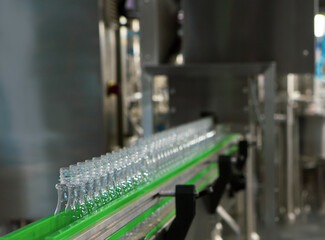 Process of water bottling plant. Plastic bottle on conveyor belt in beverage factory.