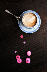 cup of coffee and plum flowers on the table