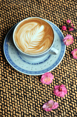 cup of coffee and plum flowers on the table
