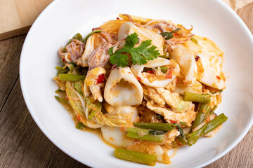 Sukiyaki dried squid Thai food in white bowl on wooden background