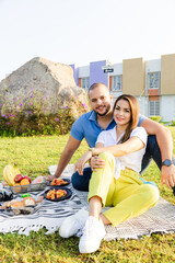 Beautiful Latin couple having a romantic breakfast with lots of tasty food and wine, sitting...