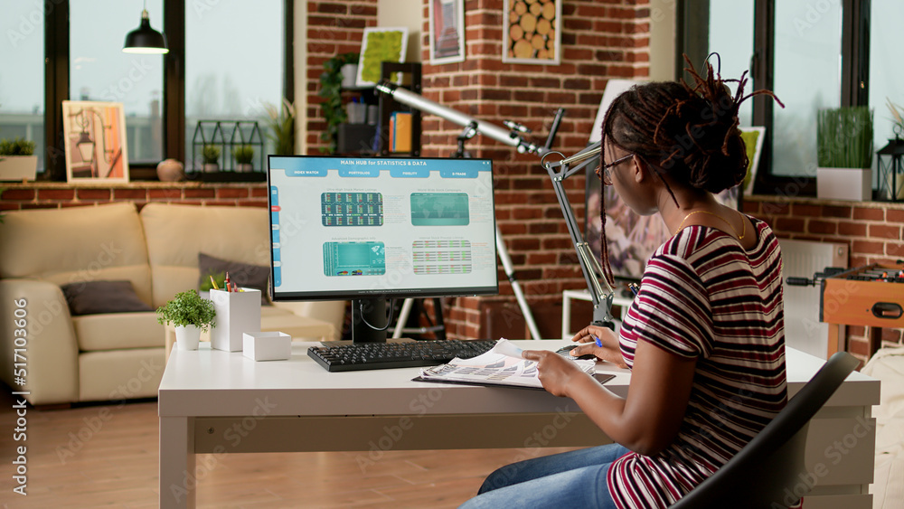 Poster company employee looking at web 3.0 software application, using computer to do remote work. working 