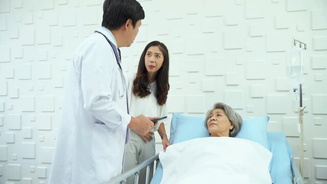 Specialist male doctor Describing the improving symptoms of an elderly female patient. Elderly female patient smiling Upon hearing better results from a male doctor.