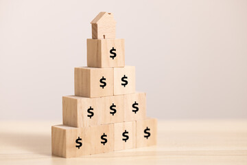 Close up stack Wooden home icon and  block to upside bar graph with dollar icon. Concept for growth graph and property price.