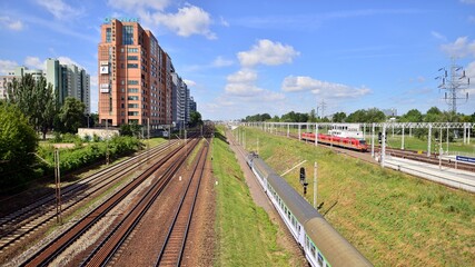 Fototapeta premium A view of the office buildings and railroad tracks from the footbridge over railway station.