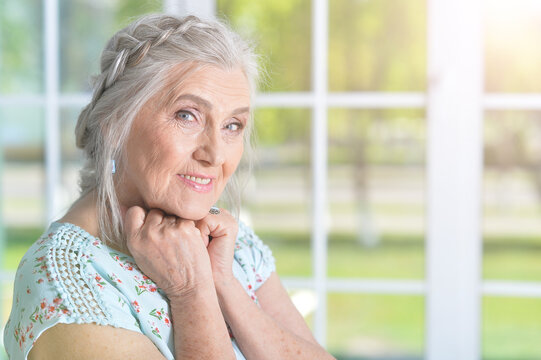 Portrait of beautiful elderly woman posing at home