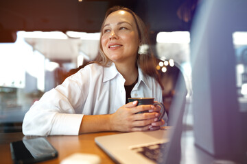 Portrait of young business woman drinking coffee in cafe
