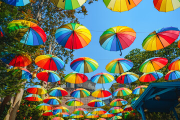 Fototapeta na wymiar Background of colorful rainbow umbrella street decoration
