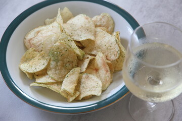 白ワインのグラスとポテトチップス