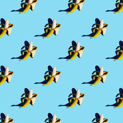 flat seamless pattern of peeled bananas on a blue background