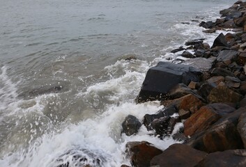 A wonderful view of the sea waves touching the rocks on the shore.
