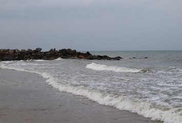 A wonderful view of the sea waves touching the rocks on the shore.