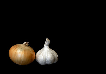  two vegetables onion and garlic on black background