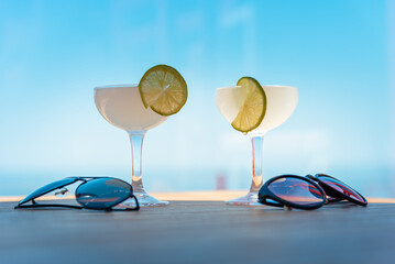Two drinking glasses of Margarita cocktails. Beach bar concept. Summer alcoholic...