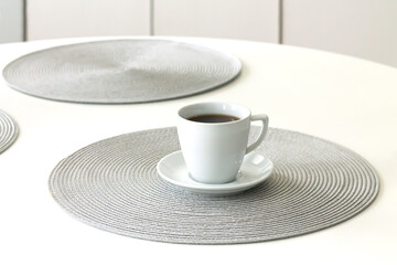 Cup of hot black coffee on kitchen table