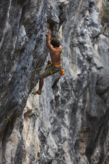 rock climber climbs the rock.