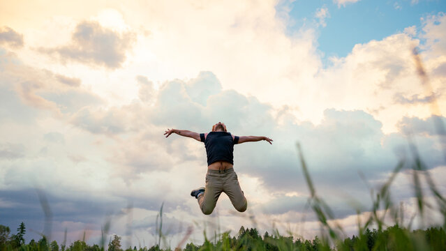 Joyful young man jumping in the air