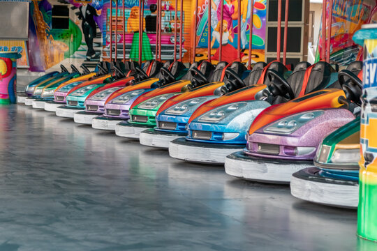 Düsseldorf, NRW, Germany - 07 14 2022: bumper cars and dodgem cars waiting for drivers on the Dusseldorfer Rheinkirmes amusement park as big parish fair and kermis in Germany for fun and action cars