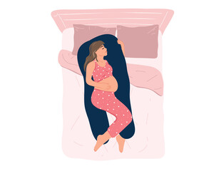 Top view young pregnant woman in pajamas sleeping on a maternity pillow on the bed. Comfortable sleeping position, healthy night sleep. Preparing for childbirth. Health and pregnancy care. Motherhood.