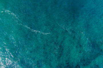 Aerial top view of green ocean surface background