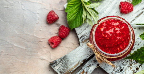 Raspberry jam with berry on light background. Homemade jam with raspberry. banner, menu, recipe place for text, top view