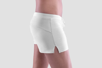 Mockup of white men's boxers on a man close-up, side view, isolated on background.