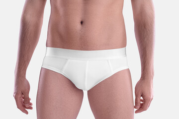 Mockup of white underpants on a sports guy, isolated on background in studio.