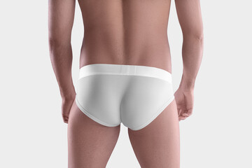 Mockup of white underpants with wide elastic band on posing athletic male body, sportswear for design, advertising, back view.